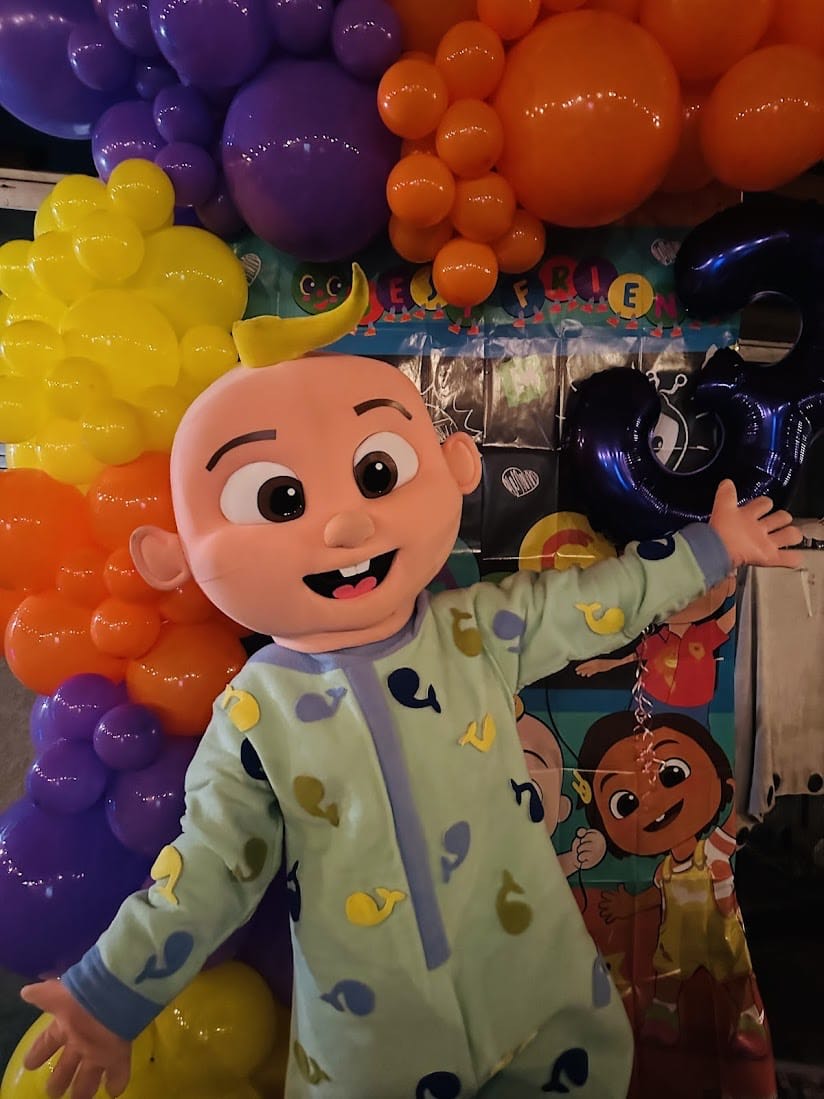 Cocomelon JJ character with kids at party